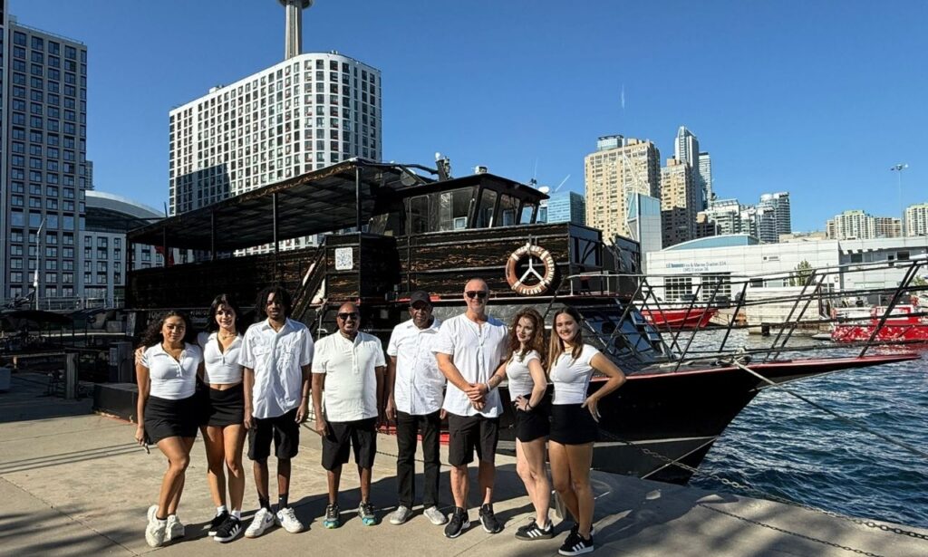 Crew beside the yacht at the Toronto waterfront